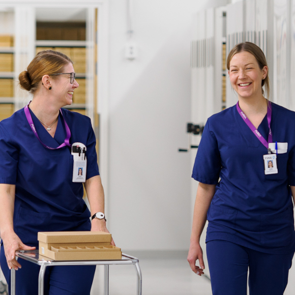 Two happy biobank employees collecting samples in the block warehouse.